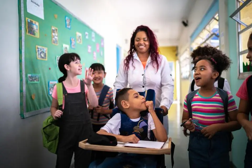 An adult reads a story to a small group of children